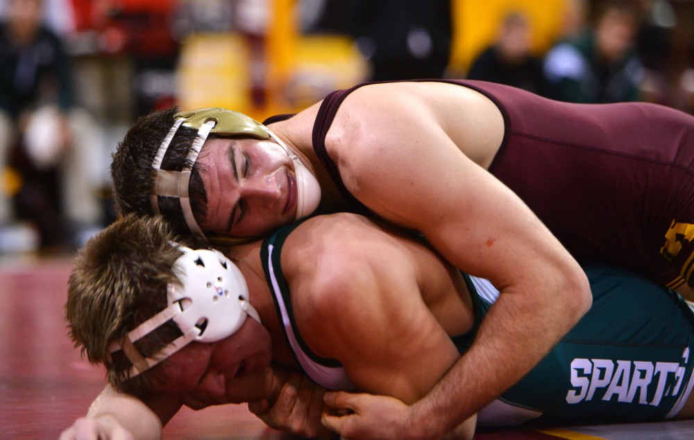 Minnesotas Tony Nelson holds down Michigan States Michael McClure on Sunday, Feb. 3, 2013, at the Sports Pavilion. 