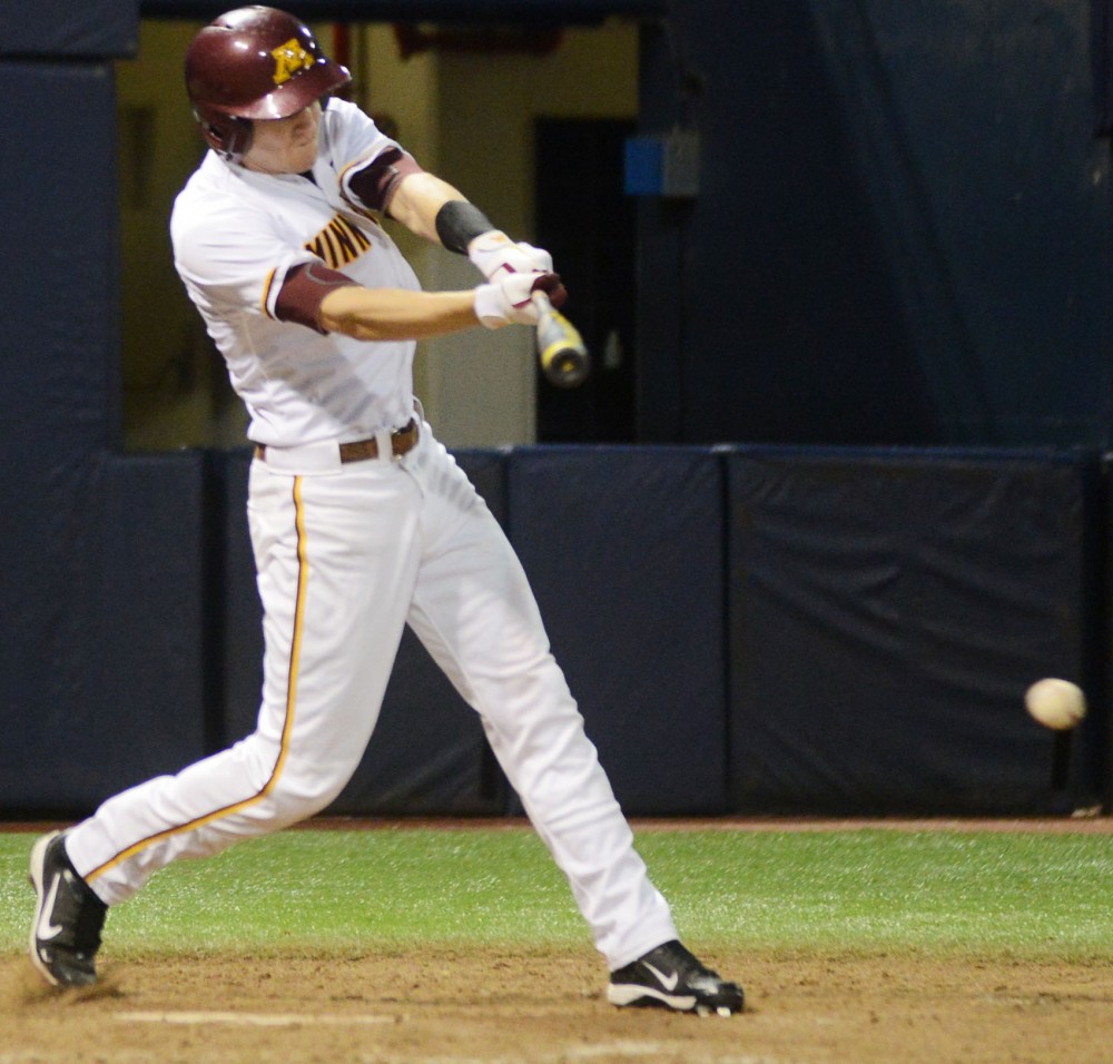 Minnesota outfielder Troy Larson hits a foul ball Tuesday, March 12, 2013, at the Metrodome.