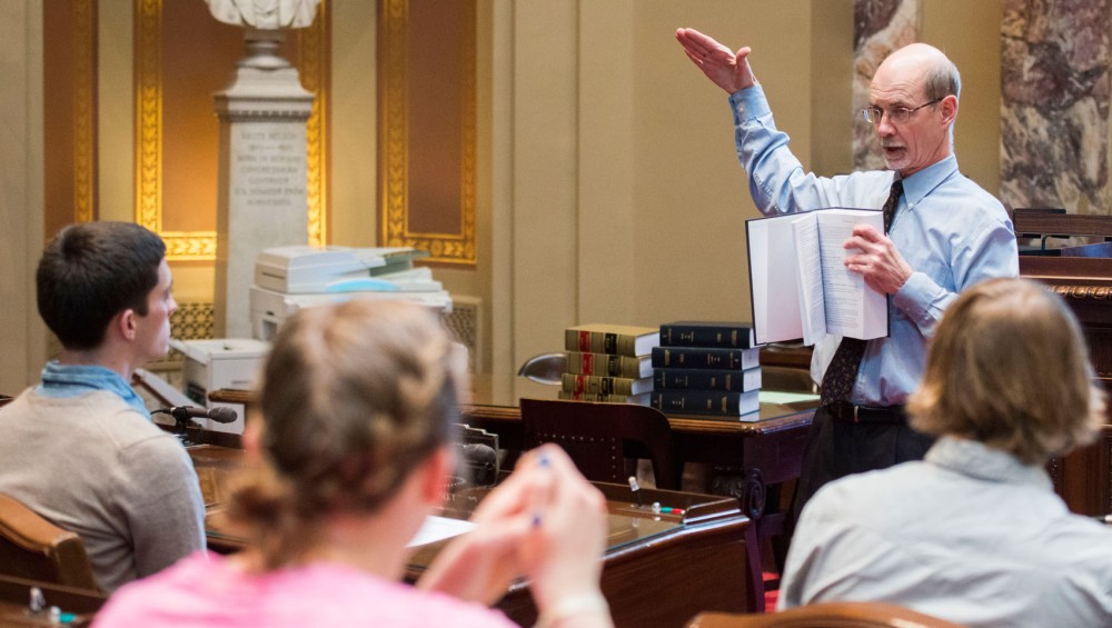 Director of the Minnesota Senate Information Office Scott Magnuson explains policy procedures to students from CFANS in the Minnesota State Senate Chambers on Thursday, April 4, 2013, at the State Capitol. A new CFANS policy engagement program allows students to learn about the political process as it relates to agriculture and the environment.