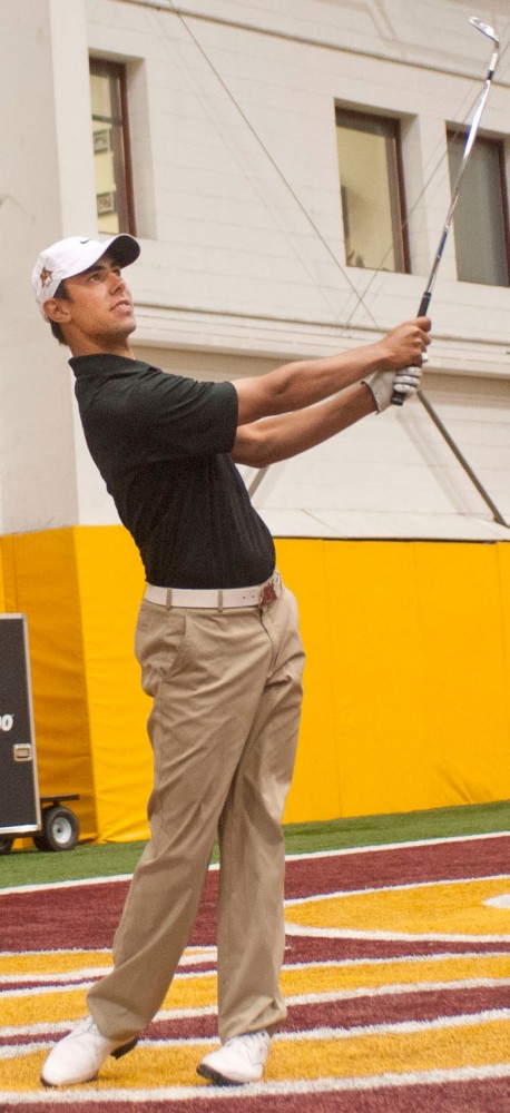 Minnesota golfer Erik van Rooyen demonstrates his golf swing Thursday, March 29, 2012, in the Bierman Field Athletic Building.