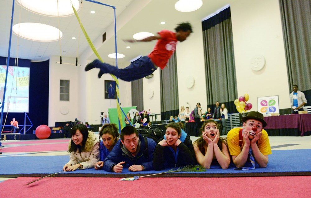 University students and Circus Mojo clown Neal Skoy  participate in an act at the Cirque De-Stress event on Wednesday, April 3, 2013, at Coffman Memorial Union. 