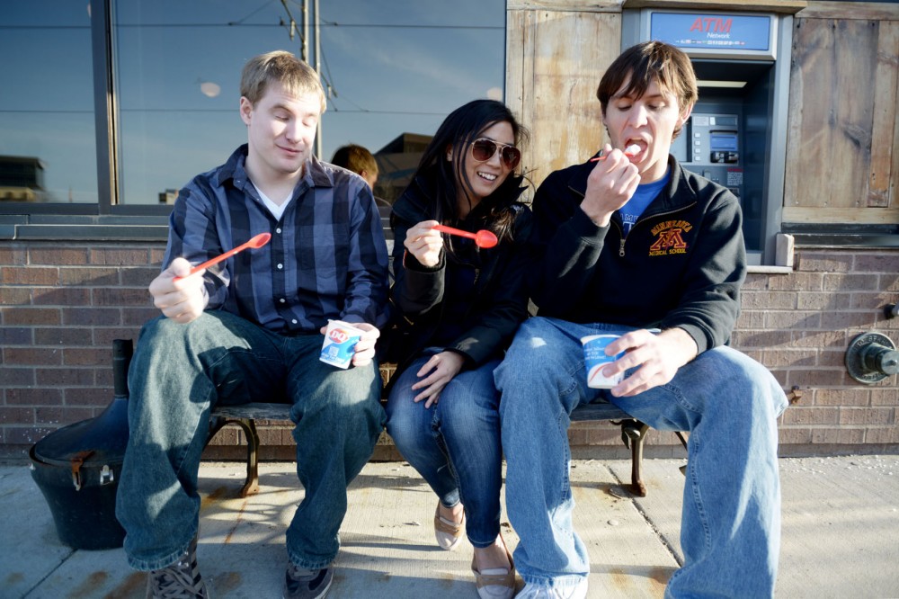 Freshman John Hokanson, third year pharmacy student Jenny Wong, and first year medical student Kyle Tamming enjoy a mini blizzard from Dairy Queen for the Taste of Stadium Village event on Thursday, April 25, 2013.