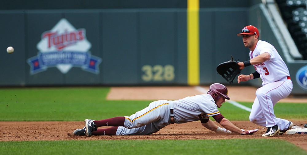 Minnesota catcher Mark Tatera dives back toward first base on May 24, 2013, during the Big Ten Tournament at Target Field.