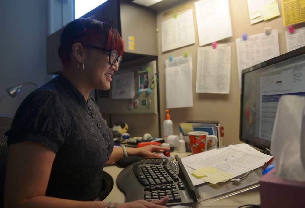 Accounts Specialist Anh Pham in her office on Tuesday July 23rd, 2013. Under the proposed changes to the Universitys healthcare plan, Pham would have to pay more for the speciality care she and her husband need.