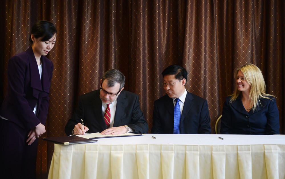 On behalf of the National Center for Food Protection and Defense, President Eric Kaler signs a memorandum of understanding with the Chinese Academy of Inspection and Quarantine. 