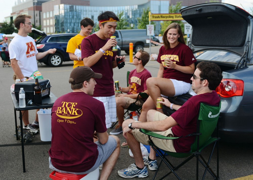 Students relax in the new student tailgate parking lot before the Gophers first football game of the season against Nevada-Las Vegas on Thursday night.

