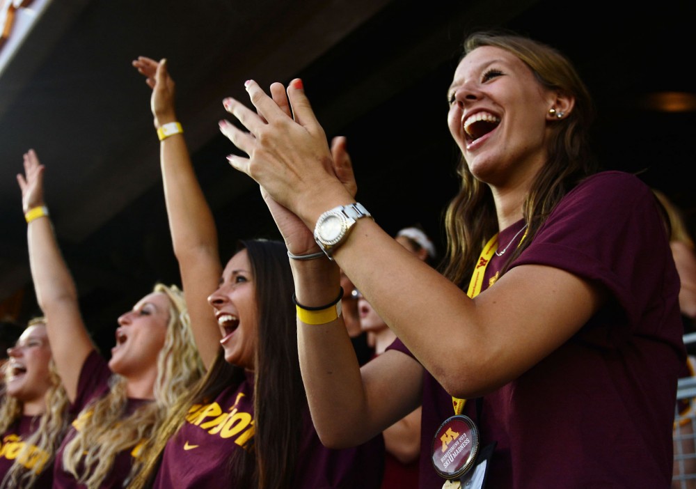 Freshman Carly Hubert, right, cheers for the Gophers at the first football game of the season against Nevada-Las Vegas at TCF Bank Stadium on Thursday night. Hubert was one of about 5,500 freshmen to receive free tickets to the game.