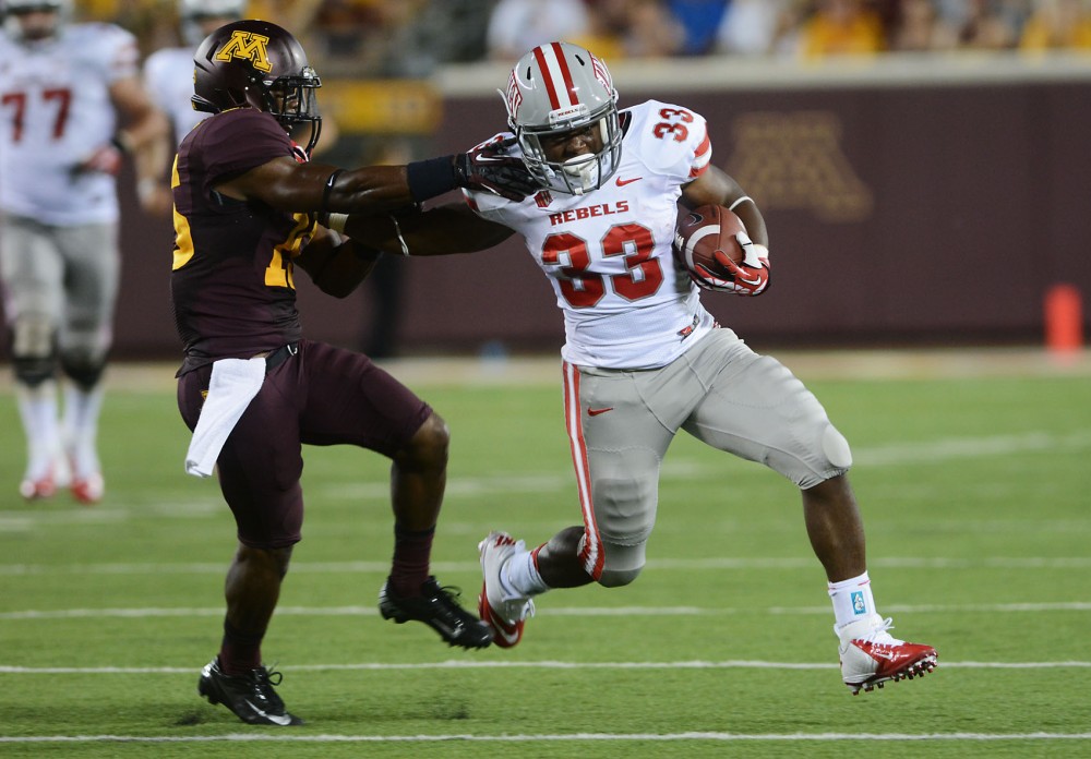Gophers defensive back Marcus Jones tackles Rebels running back Shaquille Murray-Lawrence at the first football game of the season against UNLV at TCF stadium on Thursday night. 