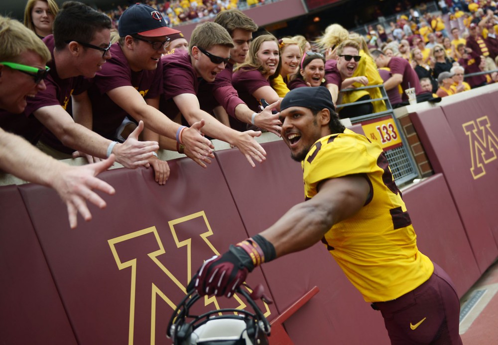Linebacker Aaron Hill celebrates with fans after winning 29-12 against Western Illinois on Saturday at TCF Bank Stadium. 