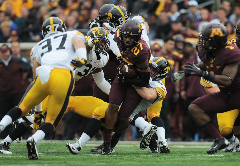 Minnesota running back David Cobb attempts to break free from a Hawkeye tackle on Saturday afternoon at TCF Bank Stadium. 