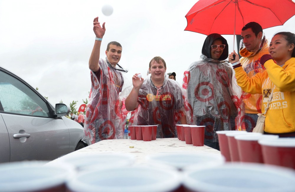 University alumni Derek Lunde, left, and economics freshman Nick Wilson play a game before the homecoming game against Iowa in the student tailgating lot outside TCF Bank Stadium on Saturday.