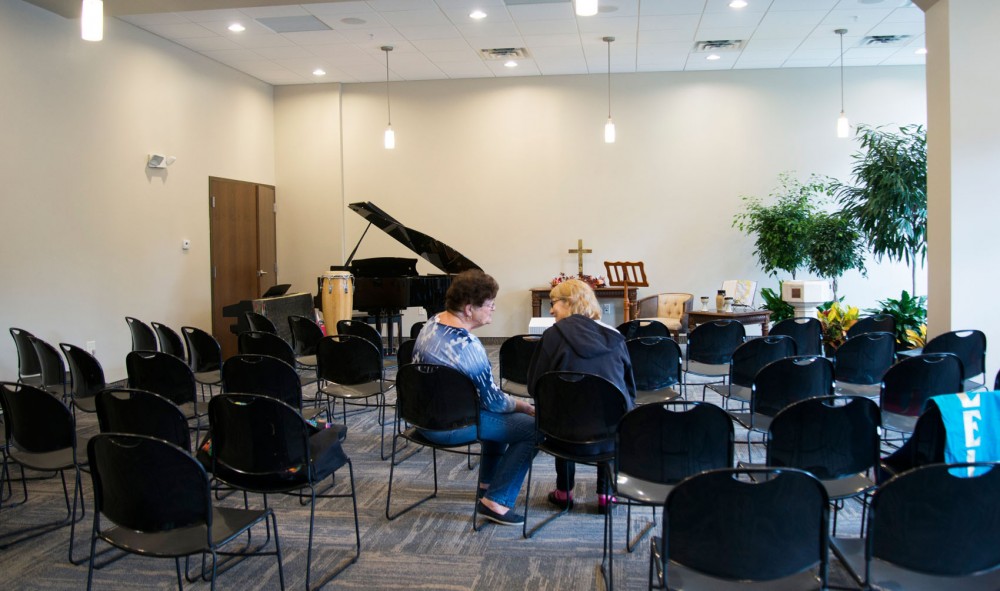 Associate in church growth Judy Maghakian speaks with pianist Elaine Klaassen on Saturday at Andrew Riverside Presbyterian Church. The church, rebuilt after a previous building collapse, is located in the first floor of The Elysian apartment complex.
