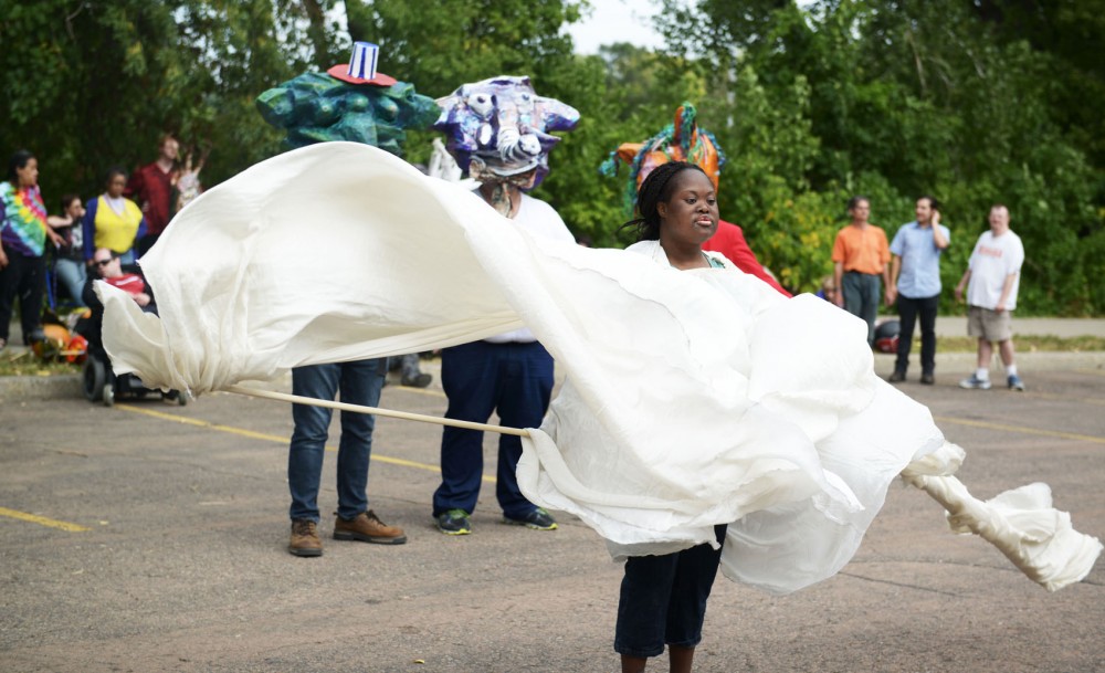 Performing artist AnnaMaria Koutsostamatis rehearses for the street festival and mask pageant, Uniquinox, on Tuesday afternoon at North Loop Playground in Minneapolis. Interact Center is known for its inclusivity for artists of all types of backgrounds. 