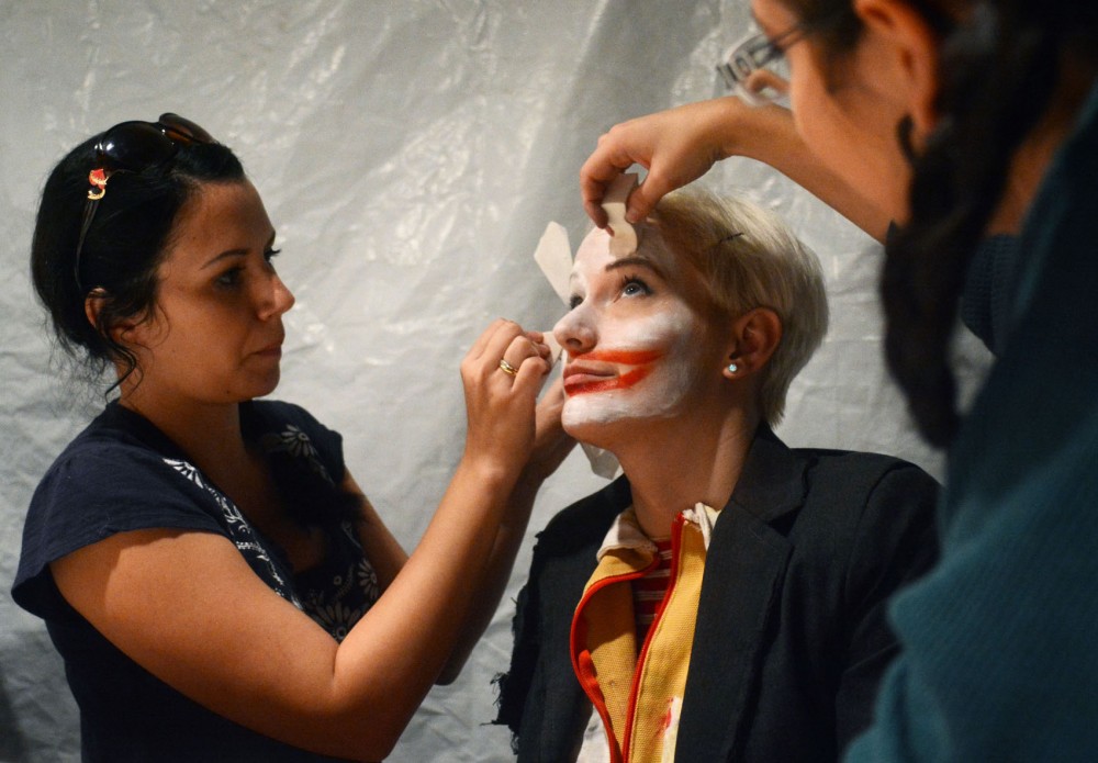 Makeup designer Kristen Leigh and makeup artist Amanda Allery paint costume designer Alli Olwells face white for a rehearsal of the Soap Factorys Haunted Basement on Sunday evening. The Haunted Basement exhibition runs October 3-November 3, 2013. 