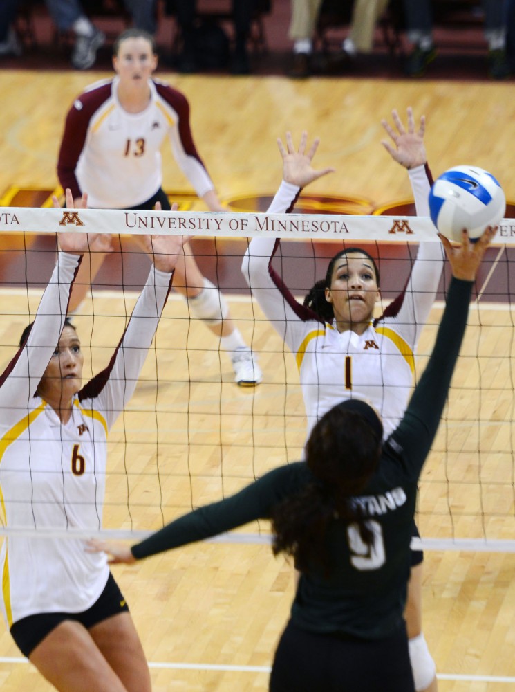 Gophers middle blocker Tori Dixon and outside hitter Daly Santana attempt to block the ball against Michigan State at the Sports Pavilion on Thursday night. Minnesota won 3-2.  