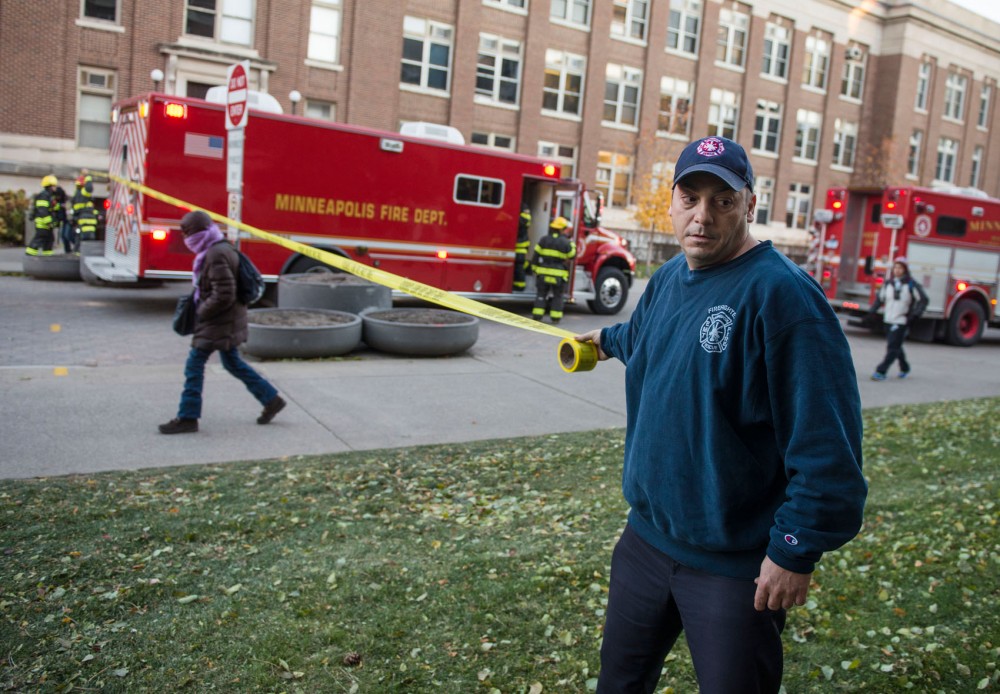 Minneapolis firefighter wraps fire line do not cross tape around the perimeter of the Mechanical Engineering building on east bask Monday around 4:00pm. Students and faculty were evacuated due to a potential gas leak.