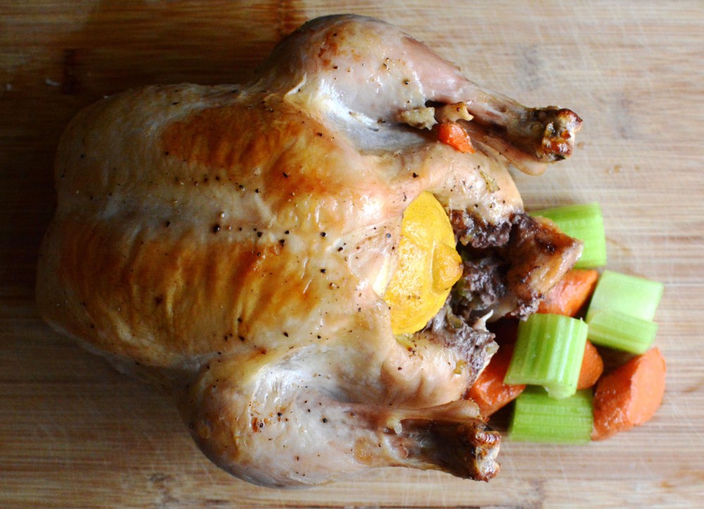 A whole roasted chicken stuffed with vegetables. 