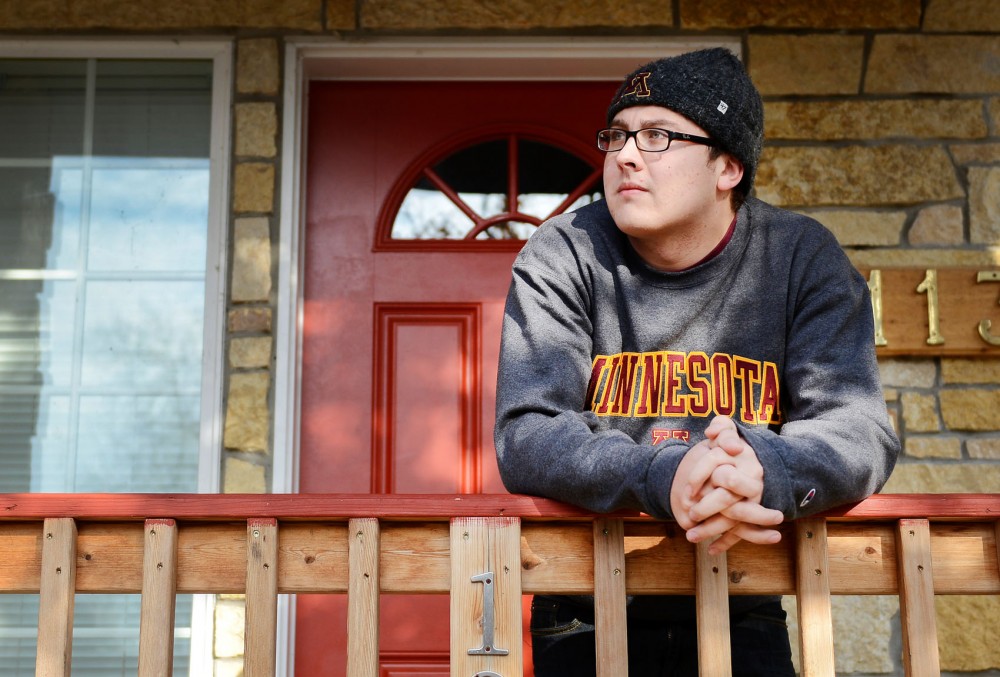 Business and education marketing sophomore Alex Granquist stands outside his home in Dinkytown on Sunday. Granquist was robbed at gunpoint on his porch at 3 a.m. on Wednesday, Nov. 20, 2013 after biking home from a friends house.