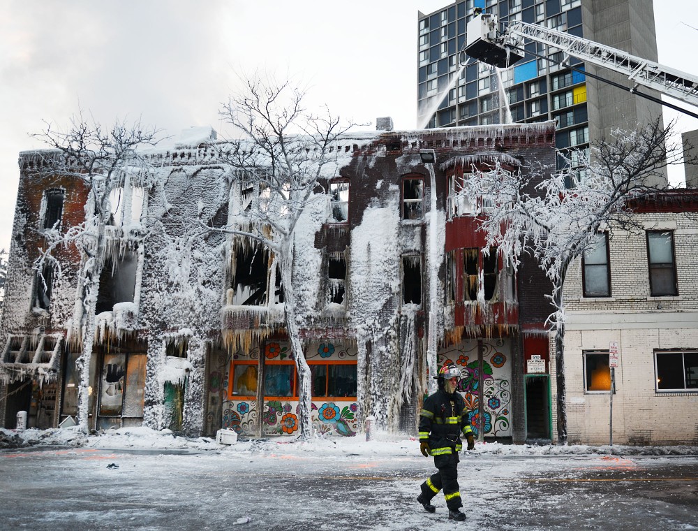 Firefighters continue to hose down Minneapolis apartments and a grocery store that exploded and caught fire Wednesday morning near Cedar Riverside. A total of 14 people were taken to hospitals, 6 in critical condition. The cause of the fire is still being investigated.