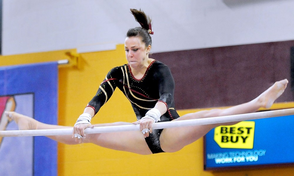 Senior Kayla Slechta competes on bars, March 9, 2013 in a quad meet at the Sports Pavilion. 