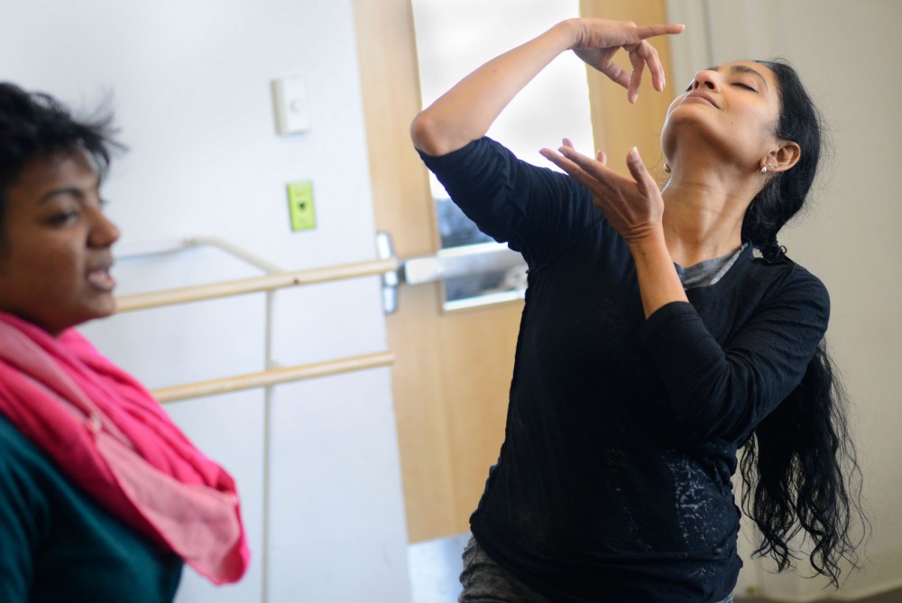 University professor and artistic director Ananya Chatterjea of Ananya Dance Theatre demonstrates to her dancers moves to portray different emotions Sunday at the Barbara Barker Center For Dance. 