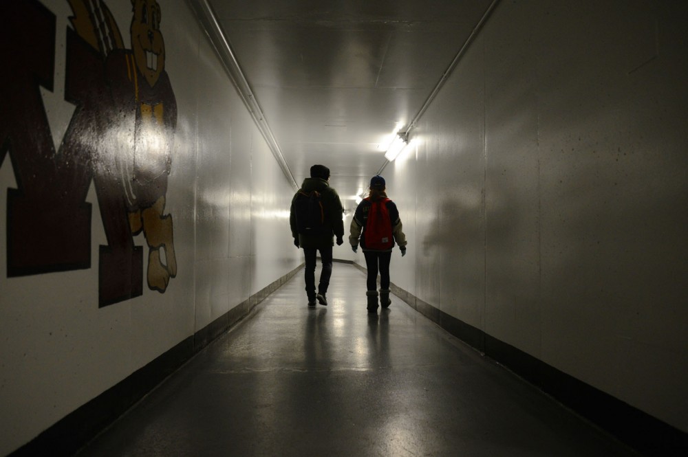 Two people walk in the Gopher Way near Nolte Hall on Monday, Feb. 17, 2014. The University updated the tunnels in the 1990s to make it easier to navigate, but students say they still have difficulty using them.  