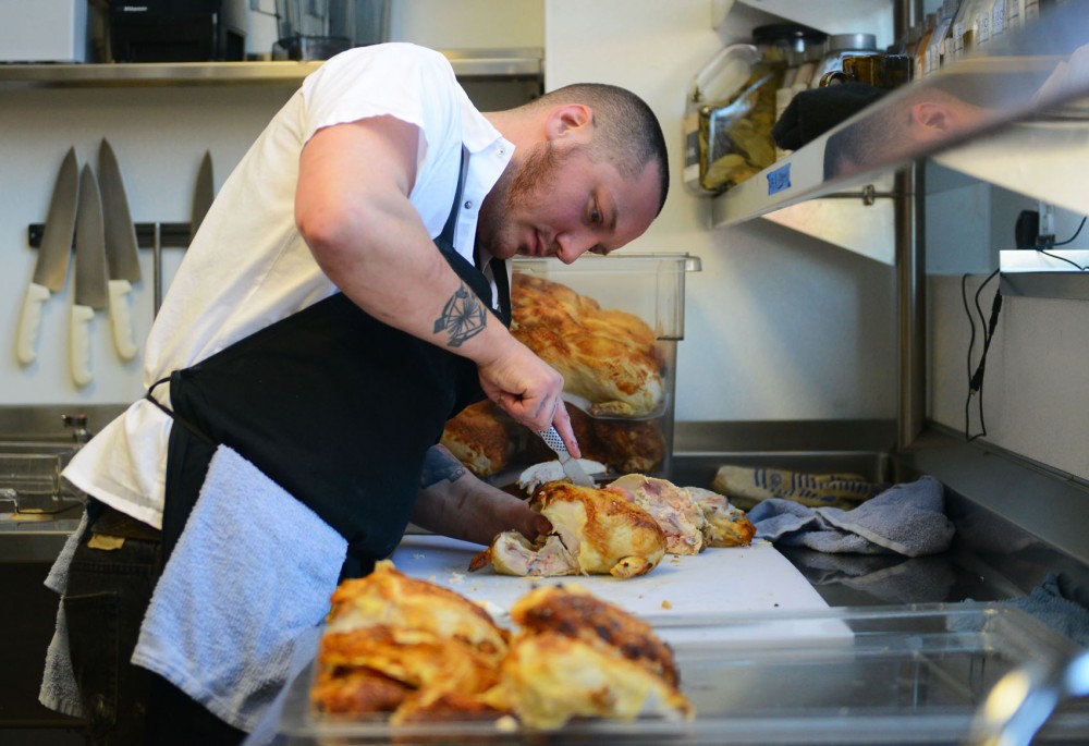 Prep Chef Aaron Colgrove prepares chicken at Coup DEtat on Tuesday.