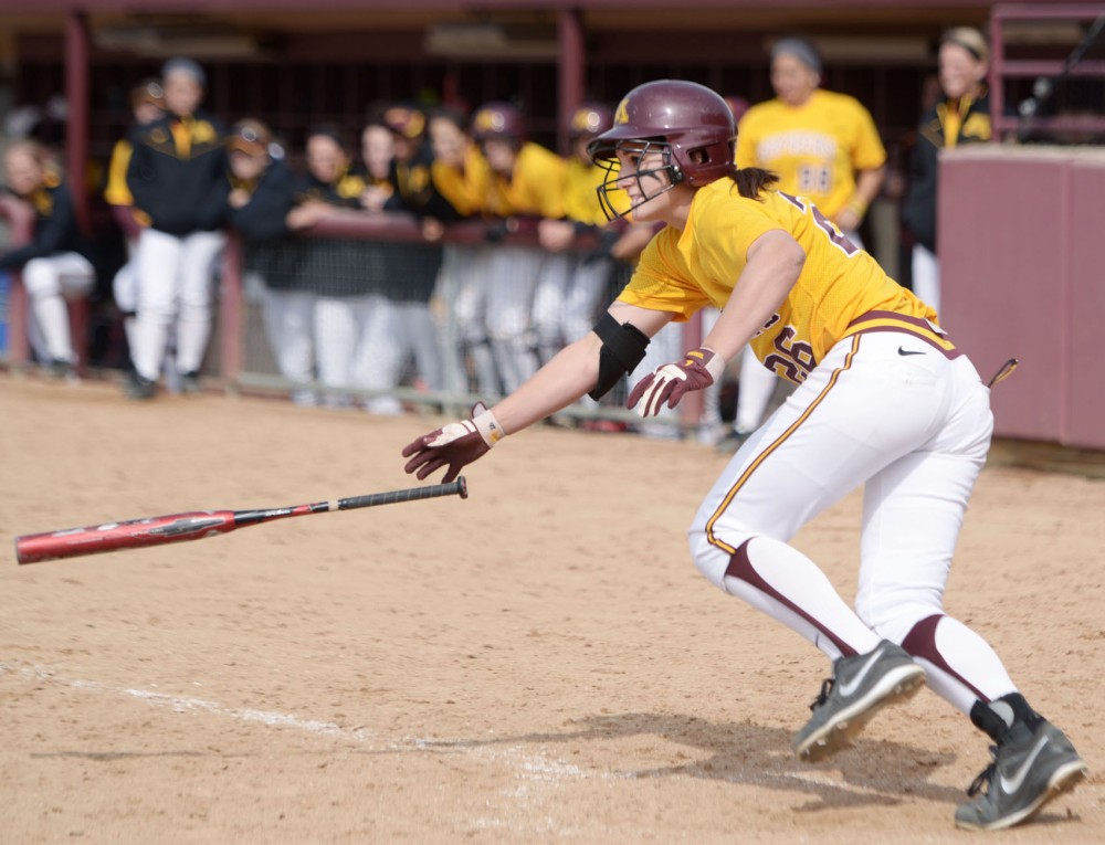Minnesota infielder Kaitlyn Richardson throws her bat after a base hit against Wisconsin on April 7, 2013, at Jane Sage Cowles Stadium.