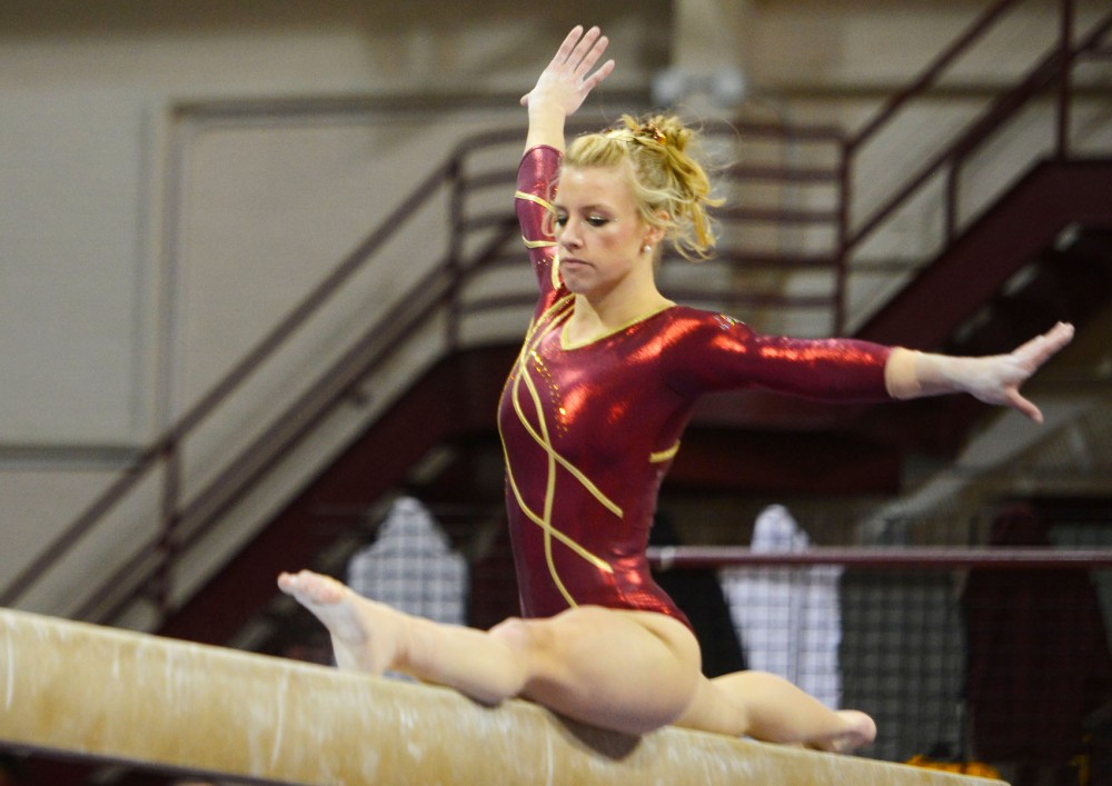 Senior Dusti Russell lands onto the beam in splits at the Sports Pavilion on Saturday afternoon. 