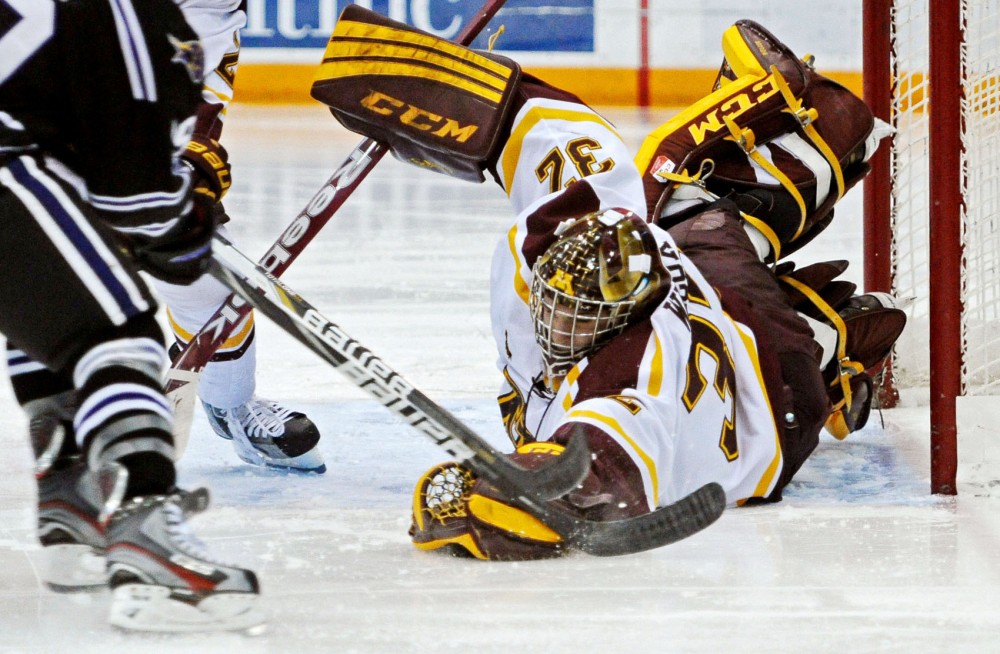Minnesota goalie Adam Wilcox grabs the puck during a game against Minnesota State-Mankato on Friday, Nov. 2, 2012, at Mariucci Arena.