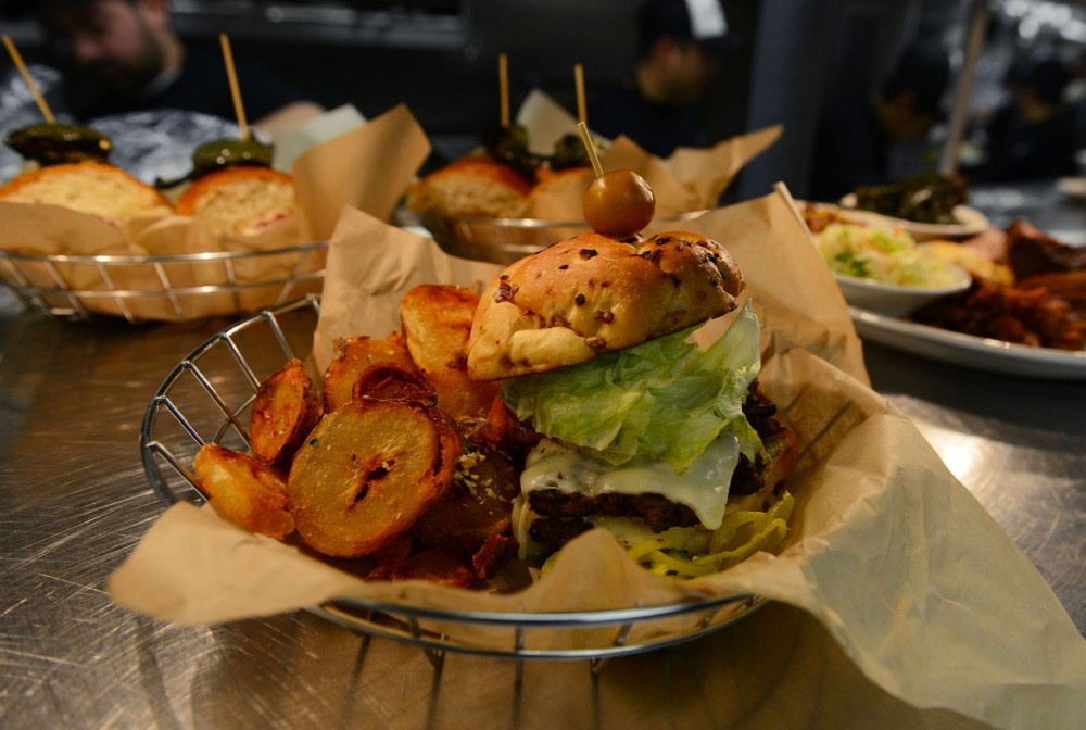 A freshly-prepared boneyard burger with cottage fries at Boneyard on Sunday. 