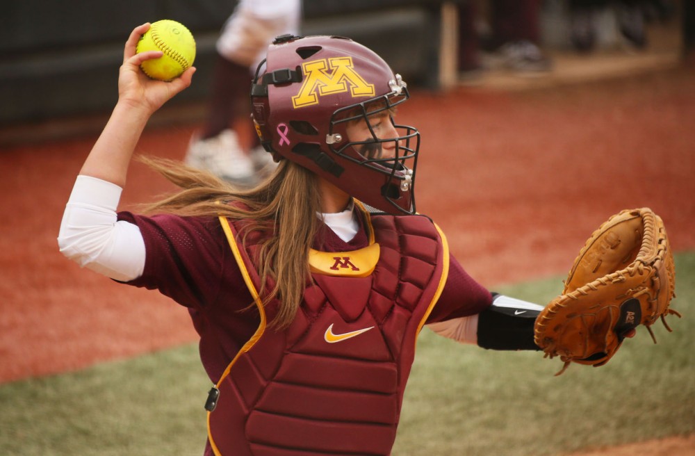 Minnesota catcher Taylor LeMay  looks to throw the ball at the game against Oklahoma State University on Friday, March 7, 2014.