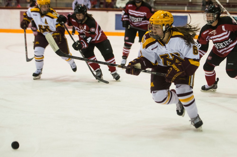 Gophers forward Kate Schipper chases down the puck during the second period on Friday, Feb. 28, 2014.  