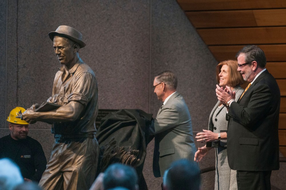 University President Kaler, Jeanie Borlaug Laube and Board of Regent Dean Johnson in McNamara unveil a statue of Nobel Prize winner Norman Borlaug on Thursday at the conclusion of the Borlaug 100-year celebration. The statue, a replica of the one at the U.S. Capitol, will be installed on the St. Paul campus.