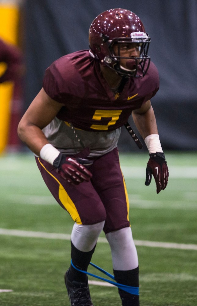 Minnesota defensive back Damarius Travis executes a typical defensive drill, running backwards with a resistance band at the Gibson/Nagurski Football Practice Facility on Thursday, March 27, 2014. 