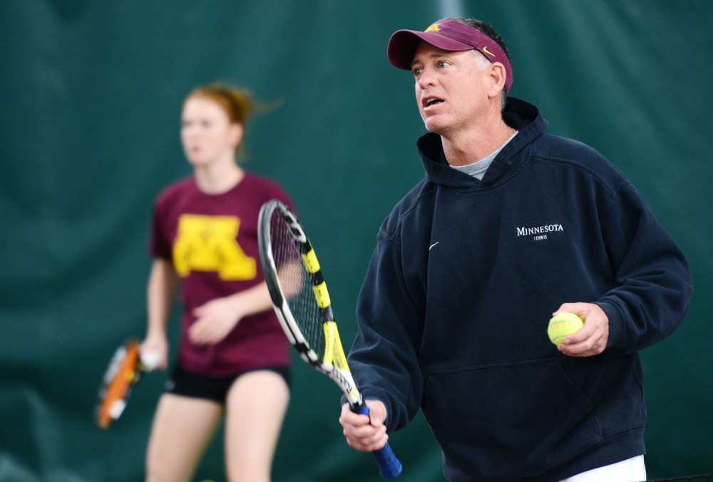 Womens Tennis coach Chuck Merzbacher directs training routines during practice Wednesday, April 3, 2013, at the Baseline Tennis Center.