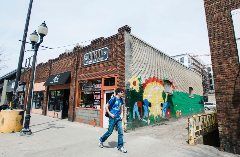 A man walks past Camdi in Dinkytown on Tuesday. The restaurant is located in one of several properties included in the historic designation study, along with Mesa Pizza and Dinkytown Tattoo.