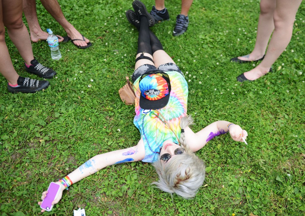 Lekresha Sears lays in the grass with friends at the Twin Cities Pride festival at Loring Park on Saturday. 