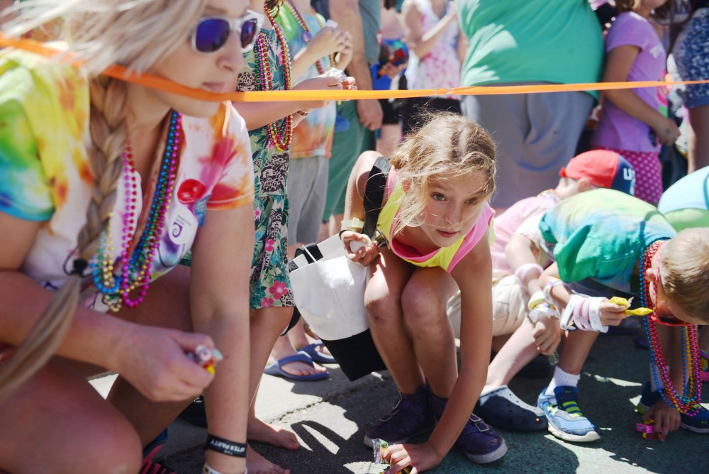 Children eagerly pick up candy left by paraders at the Twin Cities Pride parade in Minneapolis on Sunday. 