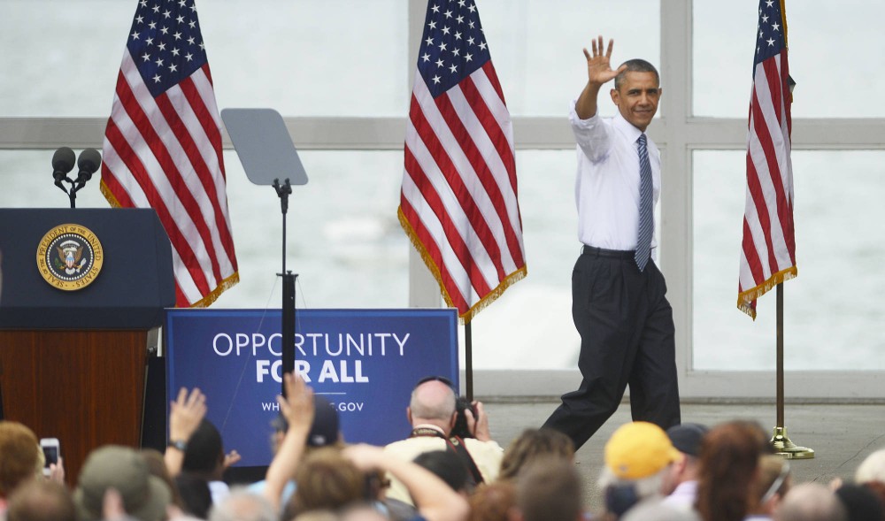 President Barack Obama waves goodbye to the crowd after giving a 30-minute speech on June 27, 2014, at the Lake Harriet Band Shell. He praised Minnesota legislation while criticizing Republicans in Congress for blocking his agenda.