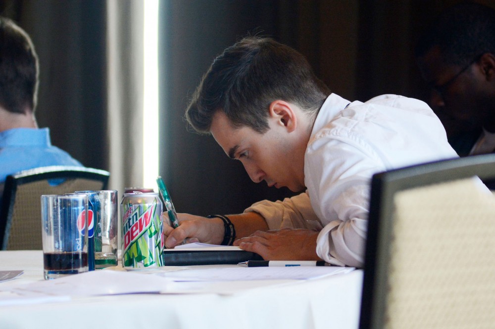 Senior Tyler Tracy takes notes during the Minnesota Cup semi-finalist workshop on Wednesday. Tracys company, GoSolar! Kids, attempts to enlighten and teach kids about solar energy.
