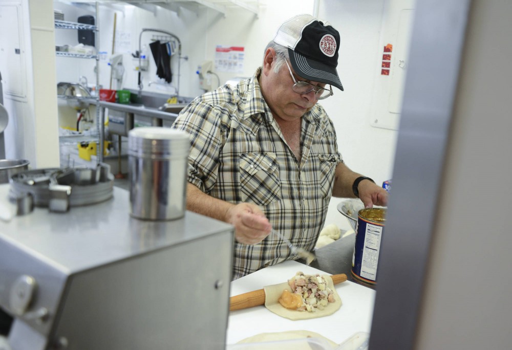 Lands End Pasty Company co-owner John Earl makes pasties on Monday at their newly opened shop located in Dinkydale Mall. Pasties are savory meat pies that originate from the south of England. 