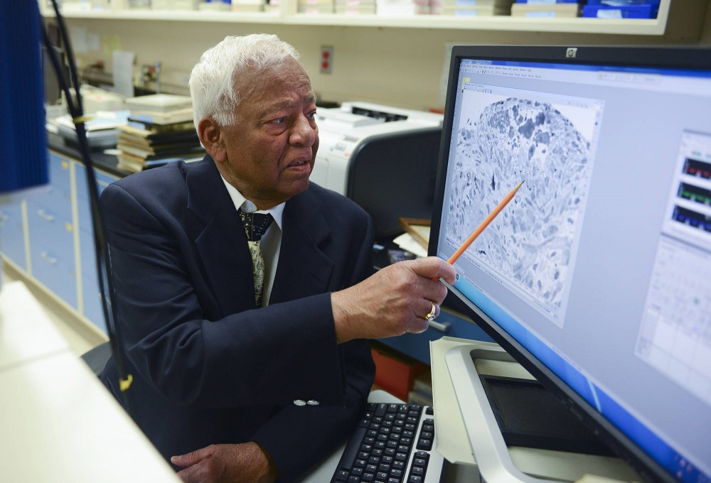 Adjunct professor Akhouri Sinha views a picture of human cells at the Minneapolis Veterans Affairs Medical Center on Monday. Sinha volunteers five days a week doing research on prostate cancer at the VA Medical Center.