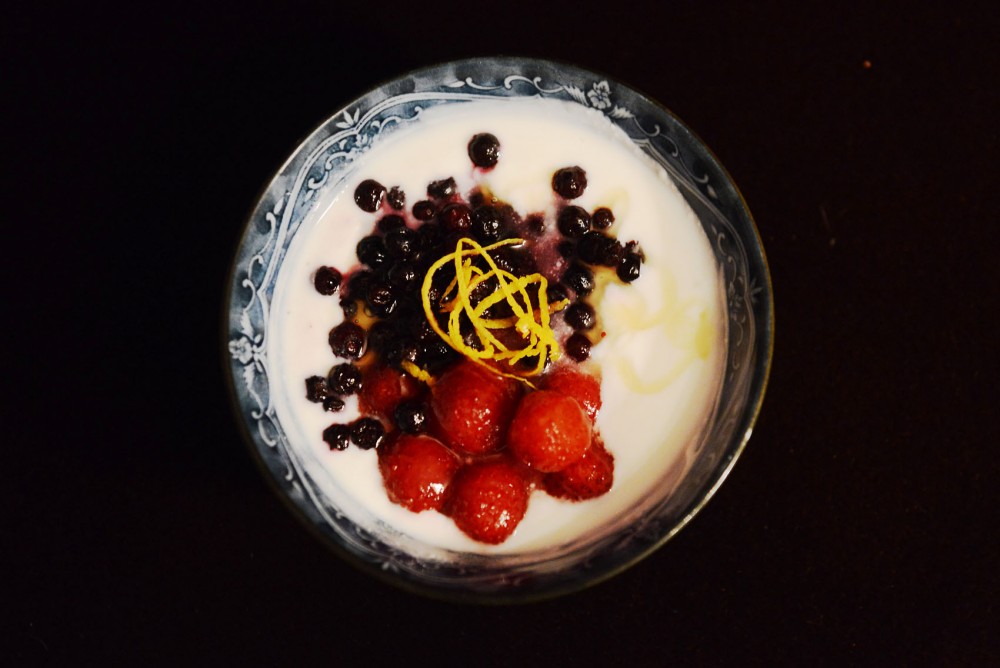 Homemade yogurt with berries, orange zest and honey make for a sweet snack or breakfast.