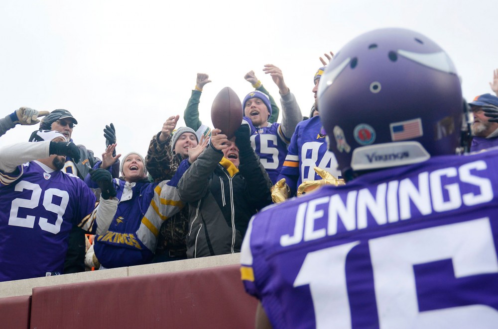Minnesota wide receiver Greg Jennings throws the ball to fans after scoring a touchdown Sunday at TCF Bank Stadium.