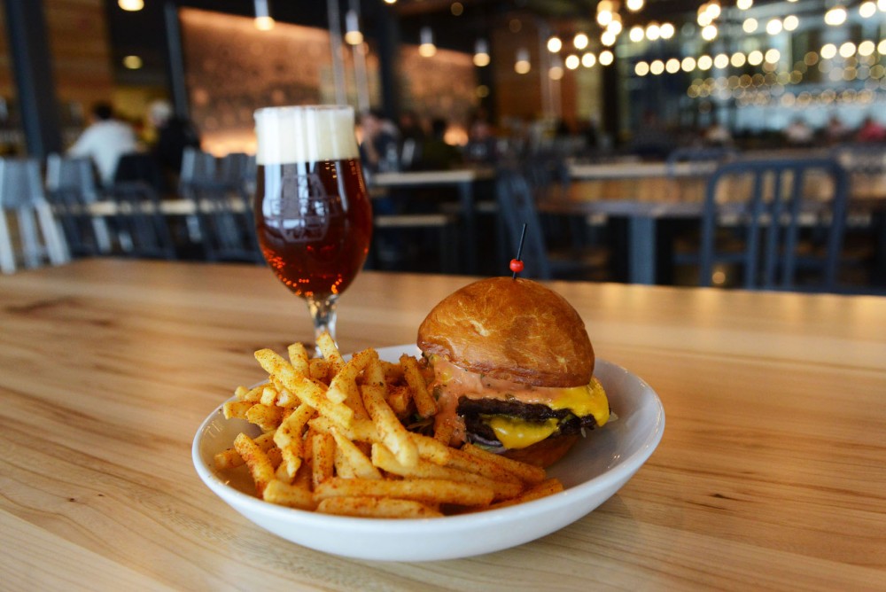 A Surly burger with french fries pairs nicely with a Surly Furious beer at the recently-opened Surly Beer Hall in Prospect Park. The Beer Hall offers a wide selection of lunch and dinner food, along with an extensive lineup of beers on tap. 