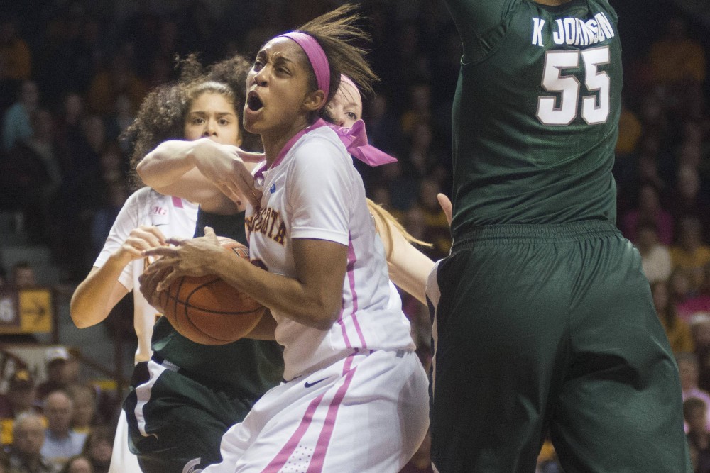 Minnesota forward Shae Kelley drives past Michigan State defenders during the second half at Williams Arena on Sunday.