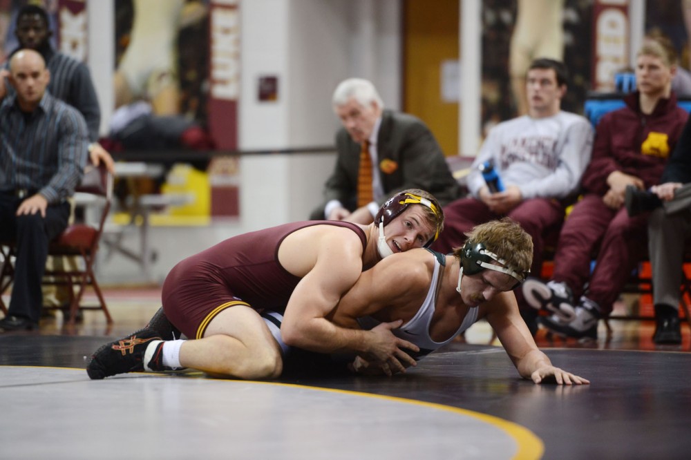 Gophers senior Logan Storley muscles against his opponent at the Sports Pavilion on Friday evening, where the Gophers mens wrestling team took on Michigan State.