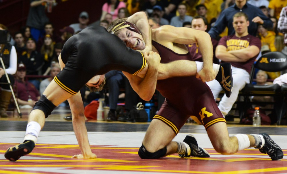 Senior Chris Dardanes wrestles during his match in the Williams Arena on Friday evening, where the Gophers took on the Iowa Hawkeyes.