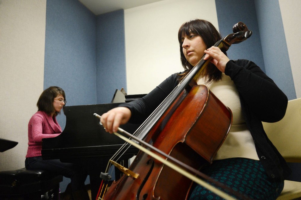 Doctor of Musical Arts first year students Carson Rose Schneider and Courtney Van Cleef rehearse in a practice room at Ferguson Hall on Monday.  Ferguson Hall recently began prohibiting non-music majors from reserving classrooms and ensemble rooms.
